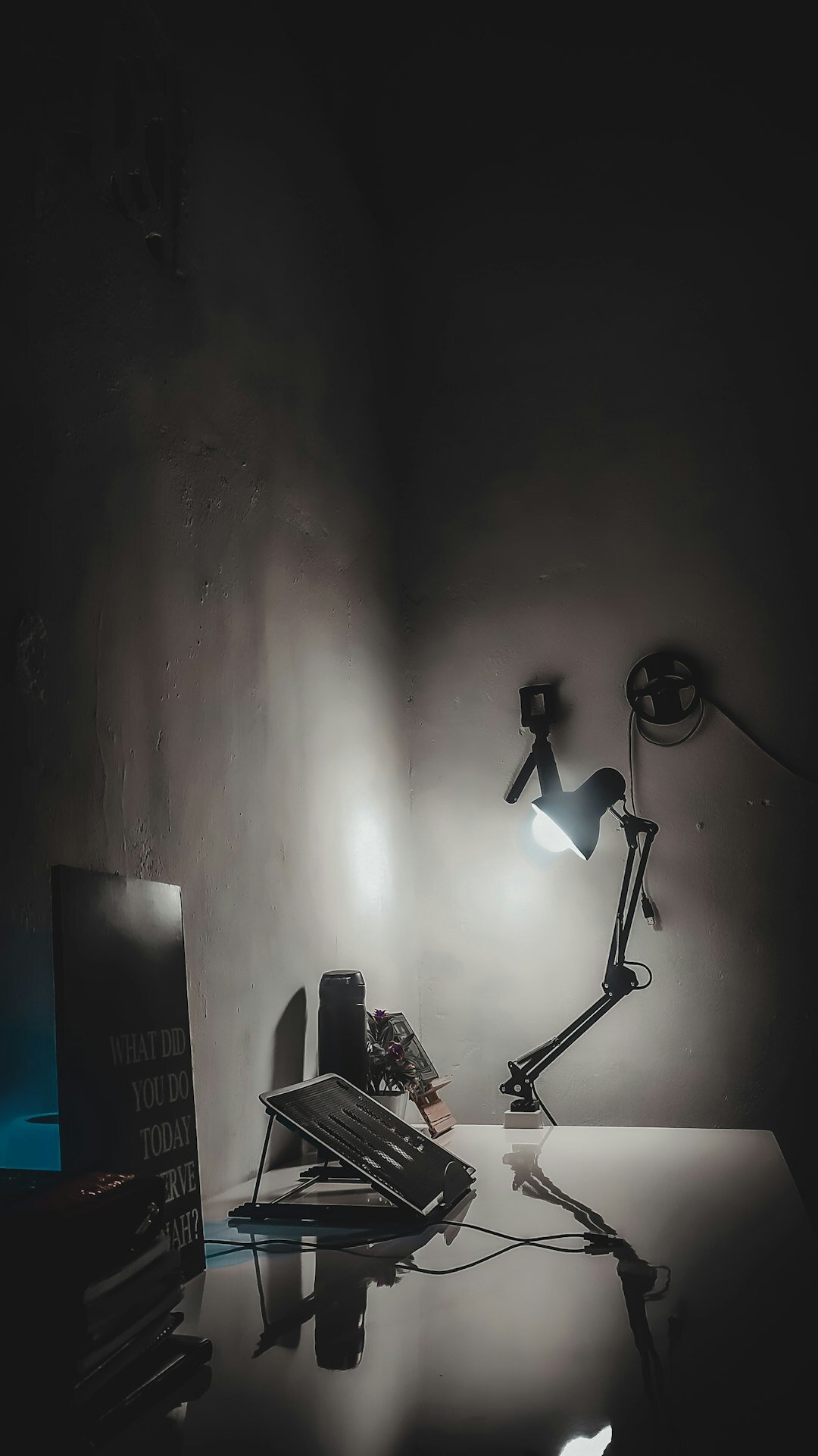 Stack of vintage detective novels with a magnifying glass and typewriter on a wooden desk
